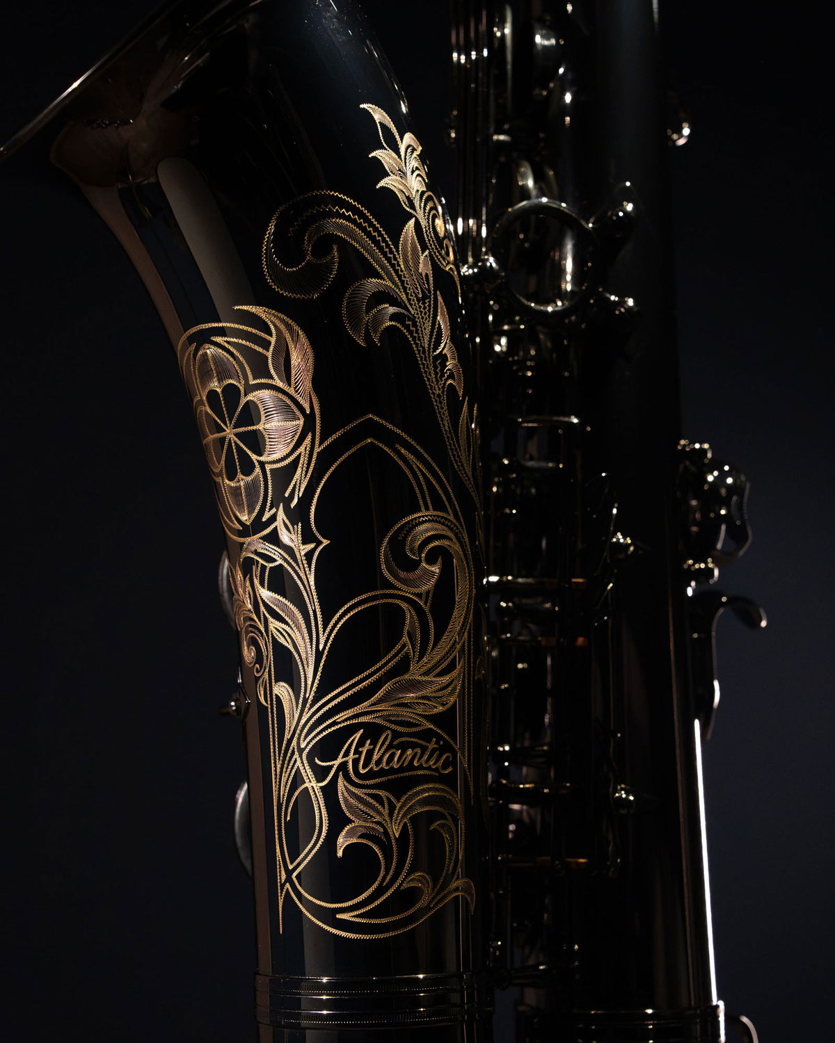 Close-up of floral hand engraving on The Baron saxophone’s black nickel plated bell